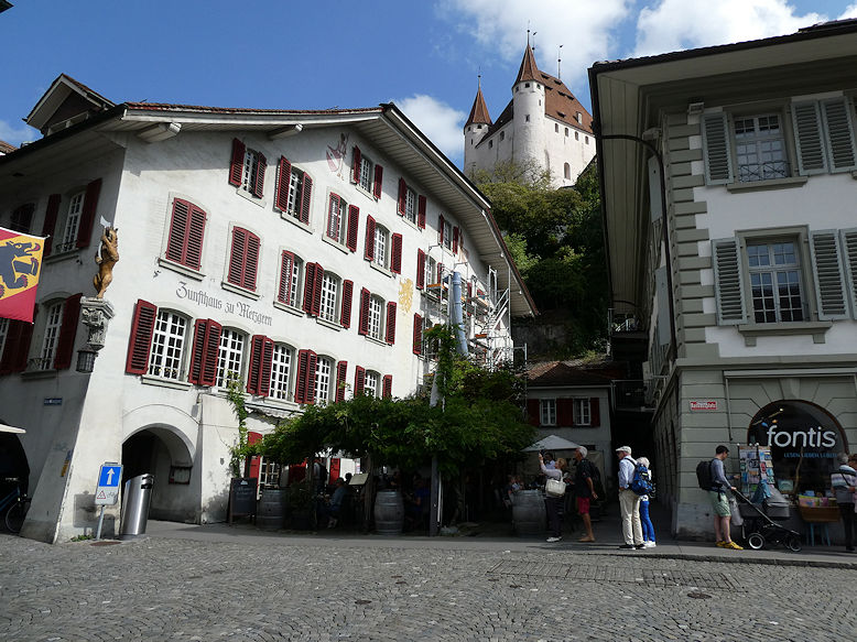 Rathausplatz with Zunfthaus zu Metzgern on the left & the Castle above